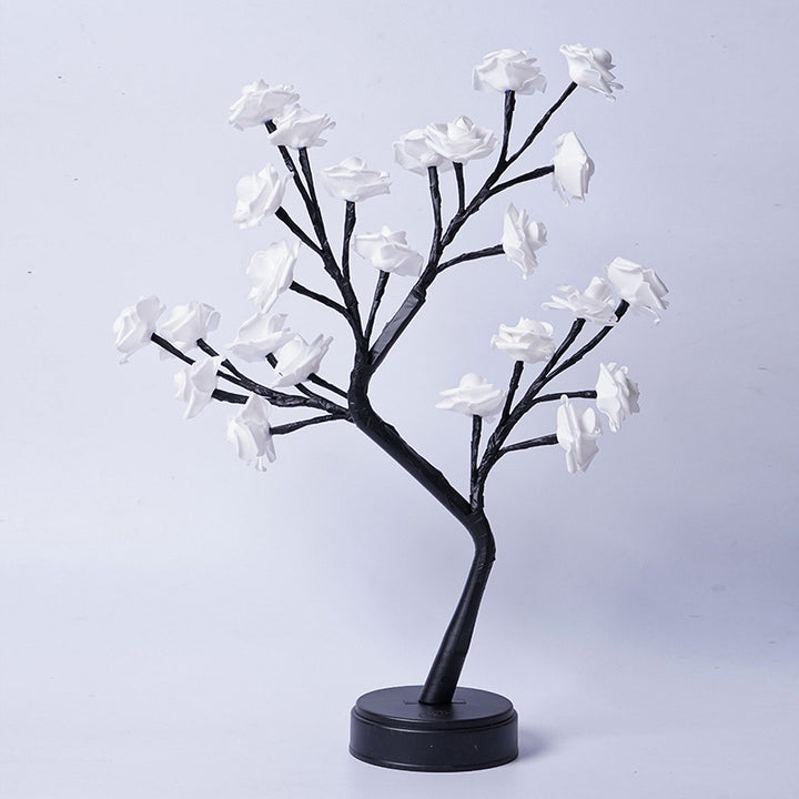 Rosenträdslampa med rosa rosor som lyser