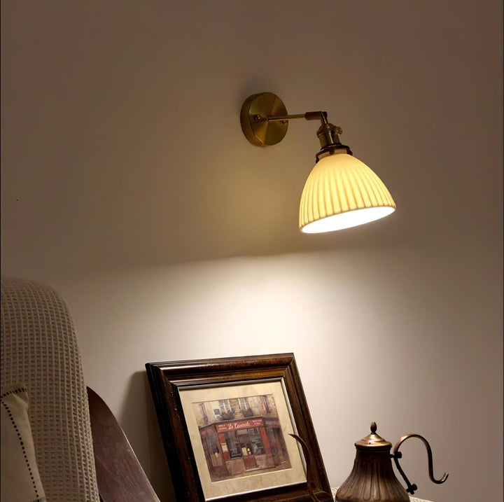 Vägglampa i keramik med plissering i mässing